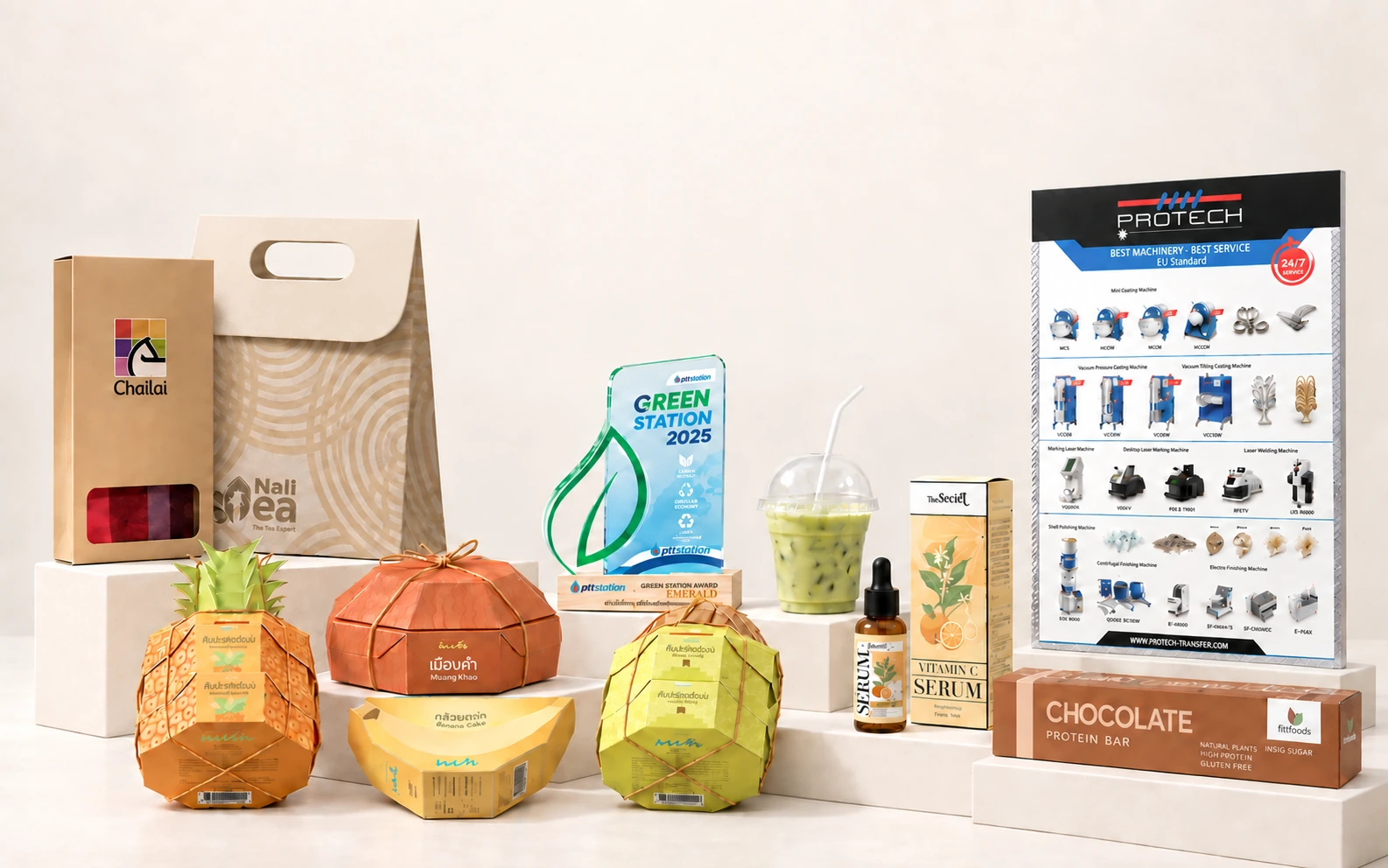 A studio mockup of a ChaiLai box, a Nali Tea bag and cup, four Phop Pra snack packages, a Green Station award, Vitamin C serum packaging, a Protech poster, and a chocolate protein bar carton